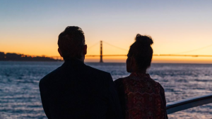 couple looking at sunset with a view of the golden gate bridge